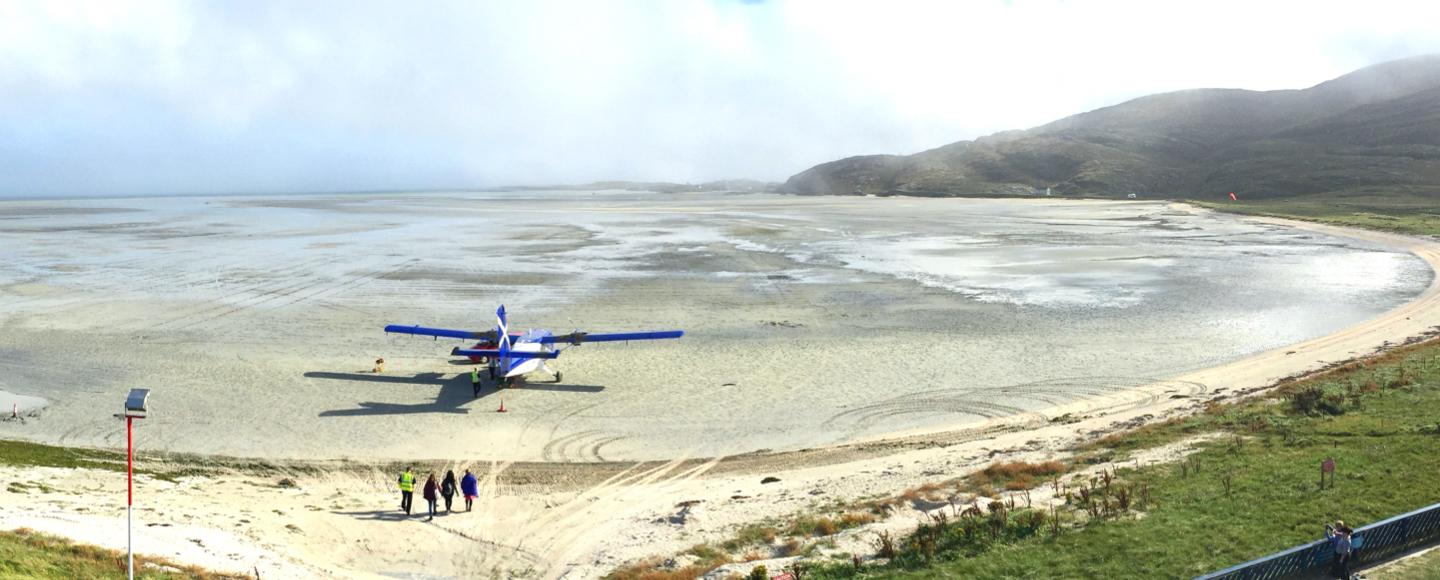 Barra Airport sandy landing strip with airplane